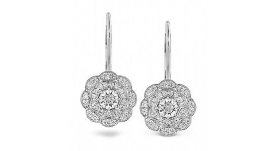 a white gold pair of floral drop earrings featuring diamonds