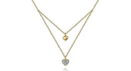 a yellow gold layered necklace featuring two heart pendants